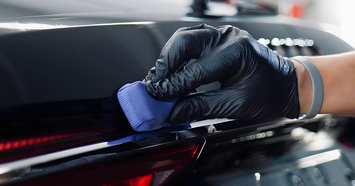 Detailer applying ceramic coating to a freshly corrected car panel
